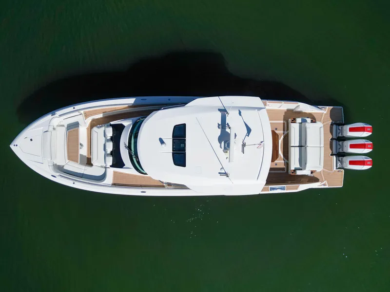 Slide: The Image of Aerial view of 2023 Tiara Yachts 48 LS on water, showcasing sleek design and triple engines. - 11