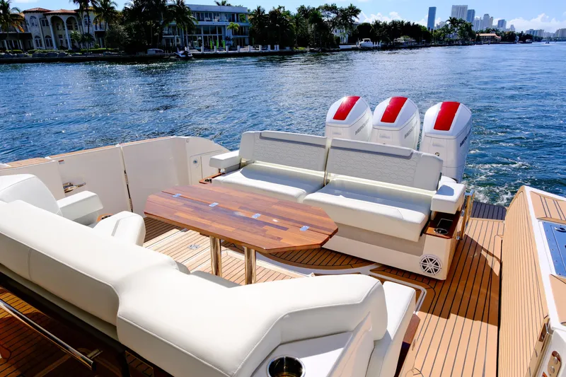 Slide: The Image of 2023 Tiara Yachts 48 LS luxury boat with spacious deck and seating, cruising on a sunny day. - 19