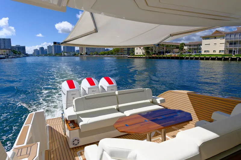 Slide: The Image of 2023 Tiara Yachts 48 LS cruising on a sunny day, featuring luxurious seating and powerful engines. - 20