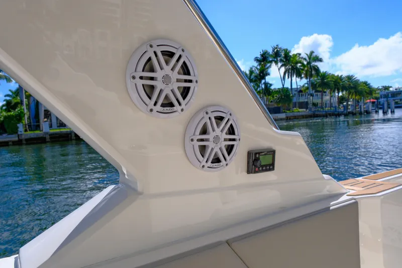 Slide: The Image of 2023 Tiara Yachts 48 LS boat speakers with waterfront view and palm trees. - 21