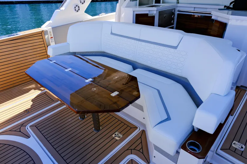 Slide: The Image of Luxurious seating area on 2023 Tiara Yachts 48 LS with elegant wooden table. - 23