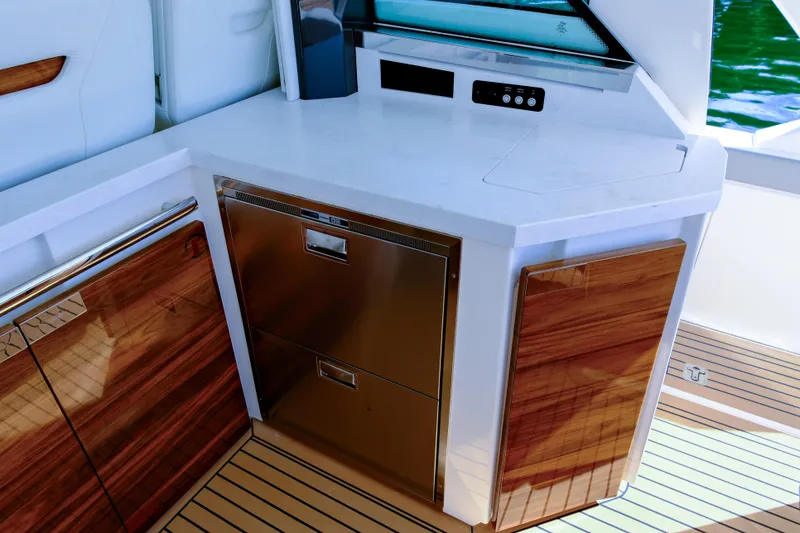 Slide: The Image of 2023 Tiara Yachts 48 LS interior with sleek cabinetry and modern appliances. - 27