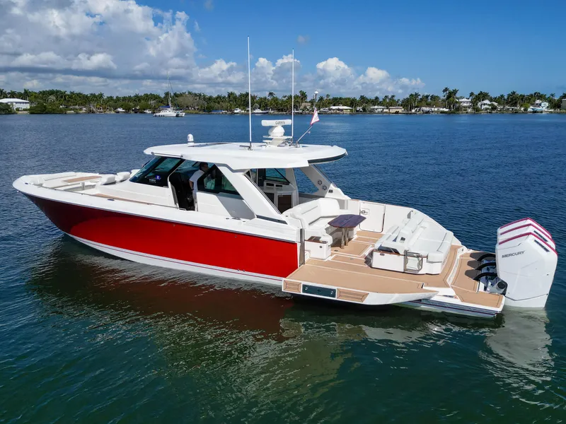 Slide: The Image of 2023 Tiara Yachts 48 LS, red and white luxury boat on calm water. - 3