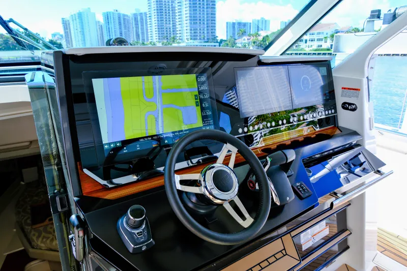 Slide: The Image of 2023 Tiara Yachts 48 LS helm with advanced navigation displays and controls. - 30