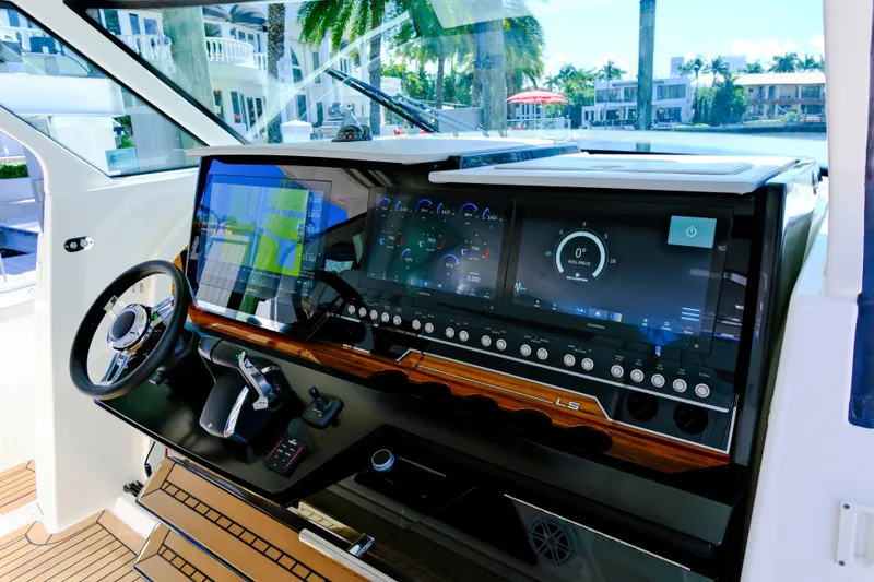 Slide: The Image of 2023 Tiara Yachts 48 LS helm with advanced navigation displays and controls. - 31
