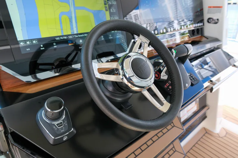 Slide: The Image of 2023 Tiara Yachts 48 LS helm with modern navigation displays and controls. - 32