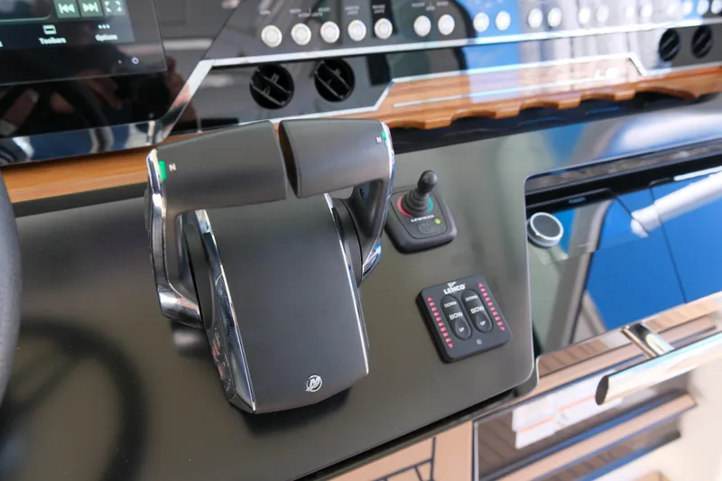 Slide: The Image of Control panel of 2023 Tiara Yachts 48 LS, featuring throttle and joystick controls. - 33