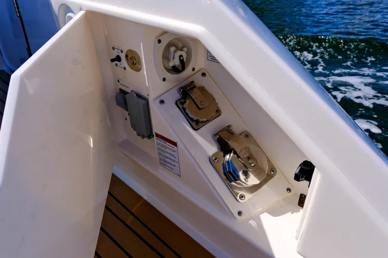 Slide: The Image of 2023 Tiara Yachts 48 LS yacht deck controls with ocean backdrop. - 41