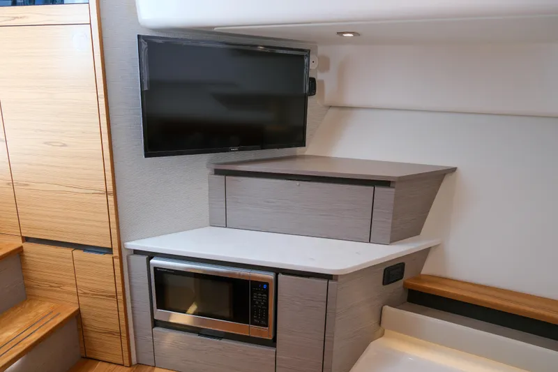 Slide: The Image of 2023 Tiara Yachts 48 LS interior with TV and microwave in modern kitchen area. - 43