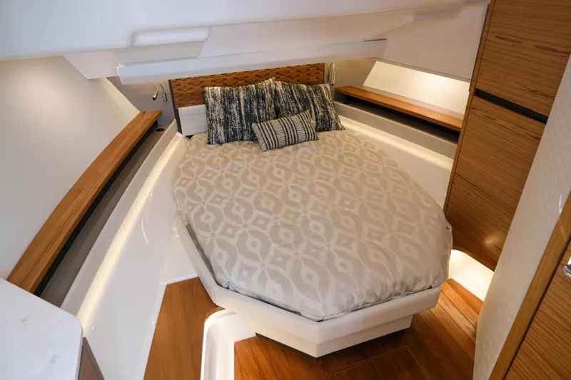 Slide: The Image of Luxurious cabin interior of 2023 Tiara Yachts 48 LS with elegant bedding and wood accents. - 45