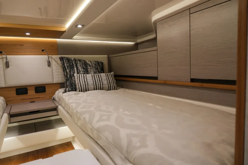 Slide: The Image of Luxurious cabin interior of 2023 Tiara Yachts 48 LS with modern bedding and ambient lighting. - 47
