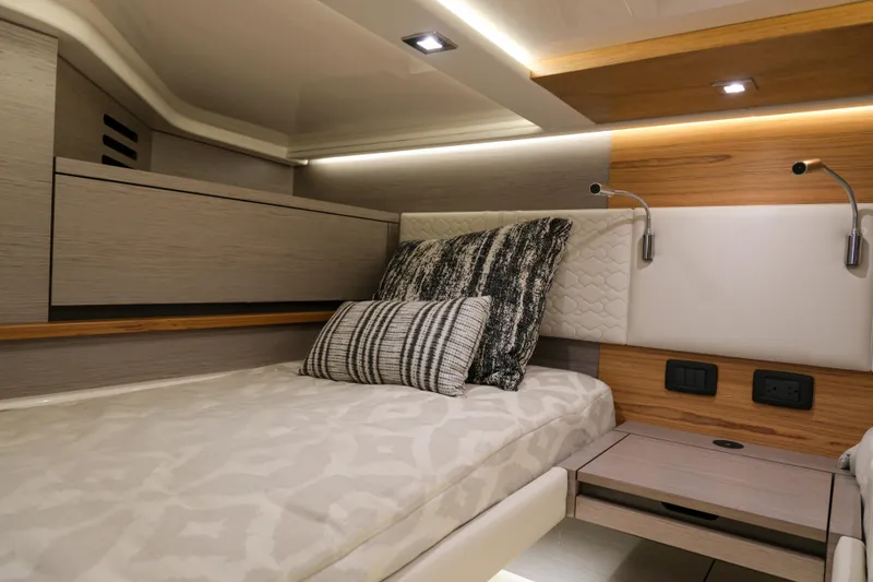 Slide: The Image of Luxurious cabin interior of 2023 Tiara Yachts 48 LS with modern design and cozy bedding. - 48