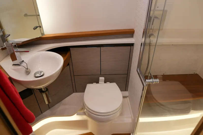 Slide: The Image of 2023 Tiara Yachts 48 LS bathroom with modern sink, toilet, and shower. - 49