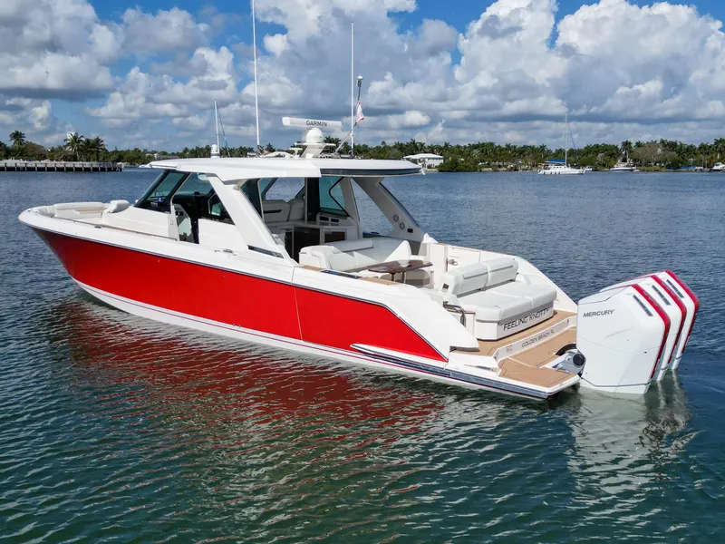 Slide: The Image of 2023 Tiara Yachts 48 LS in vibrant red, docked on a sunny day. - 5