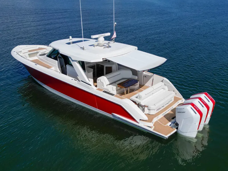 Slide: The Image of 2023 Tiara Yachts 48 LS in water, featuring sleek design and powerful outboard engines. - 7