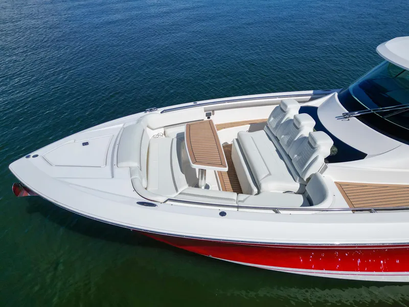 Slide: The Image of 2023 Tiara Yachts 48 LS with sleek design and spacious seating on calm water. - 9