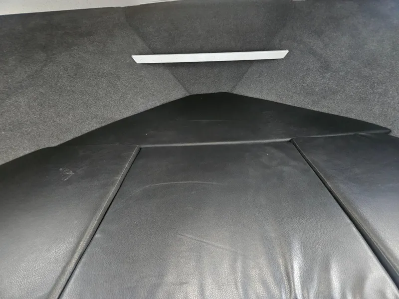 Slide: The Image of Interior view of a 2020 North River 2500s boat cabin with black seating. - 13