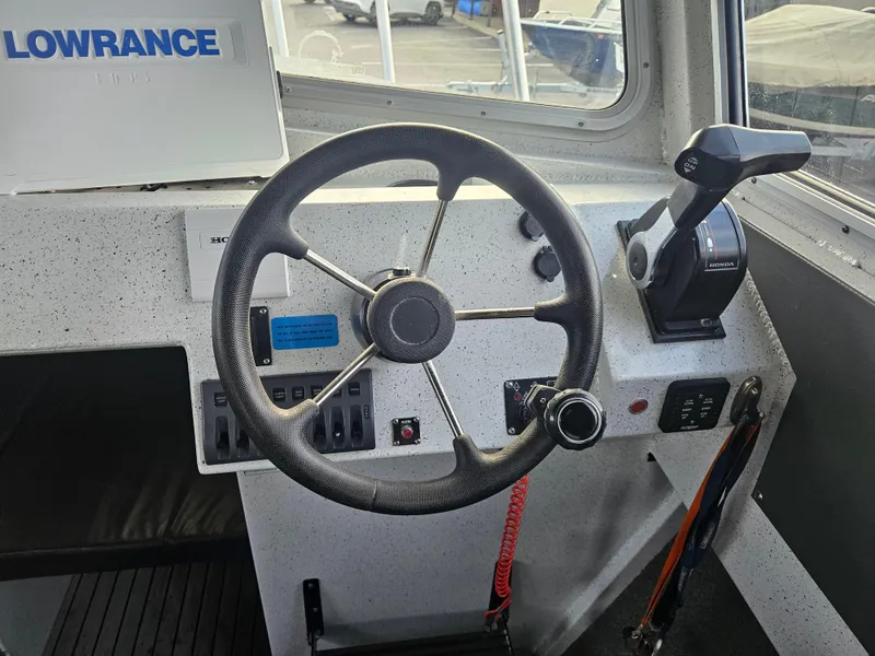 Slide: The Image of 2020 North River 2500s boat helm with steering wheel and controls. - 14