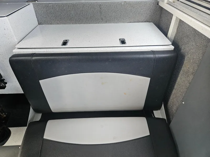 Slide: The Image of 2020 North River 2500s boat interior seating with storage compartment. - 17