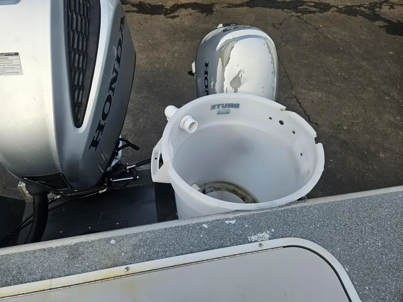 Slide: The Image of 2020 North River 2500s boat with Honda outboard motor and white plastic container. - 22