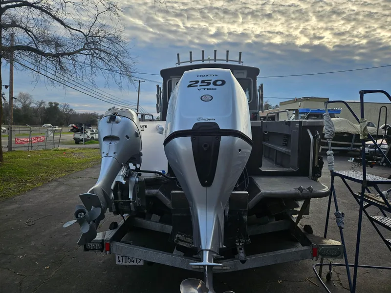 Slide: The Image of 2020 North River 2500s boat with dual outboard motors on a trailer. - 3