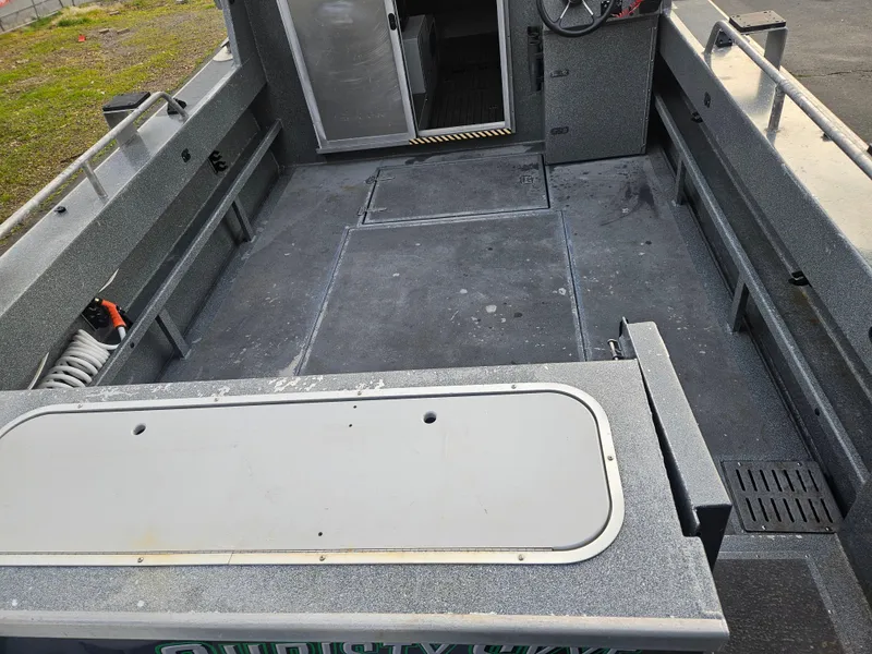 Slide: The Image of 2020 North River 2500s boat interior with spacious deck and storage compartments. - 7