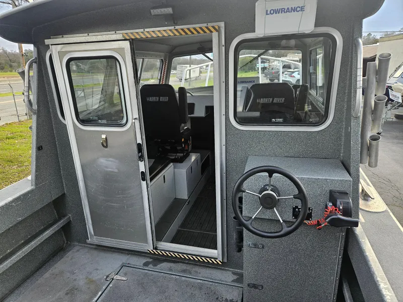 Slide: The Image of 2020 North River 2500s boat interior with steering wheel and seating. - 9