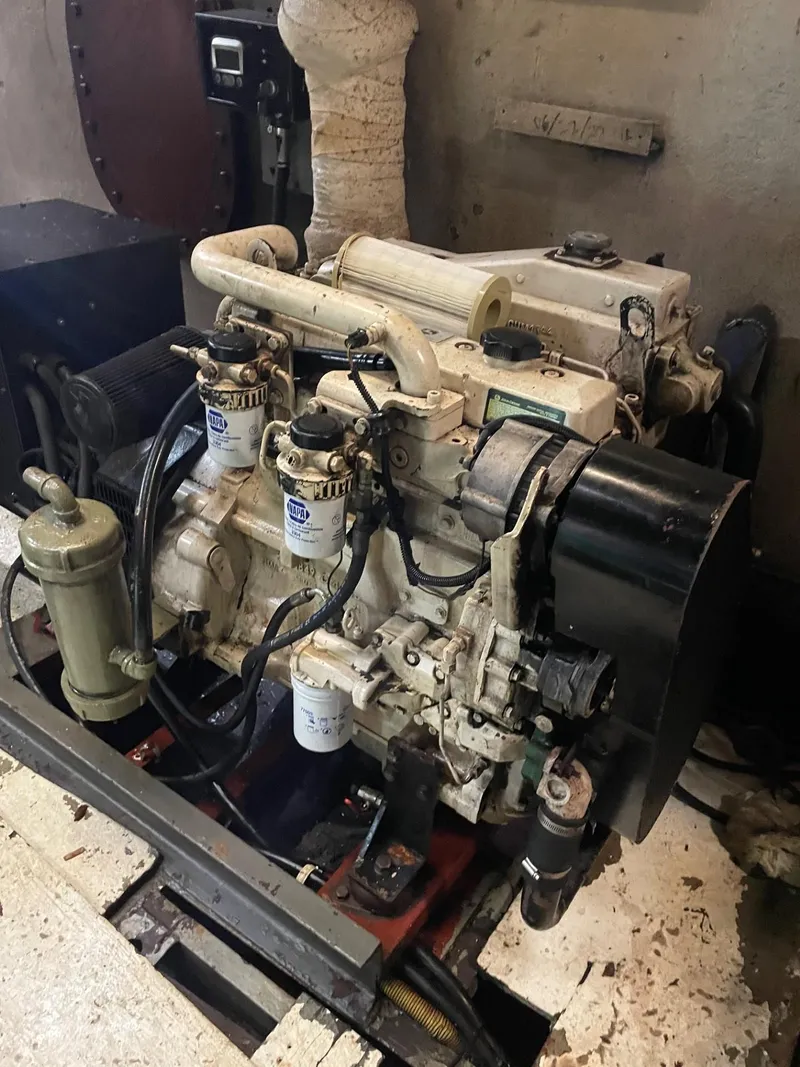 Slide: The Image of Engine room of a 1983 commercial freezer trawler with visible machinery and two people working. - 10