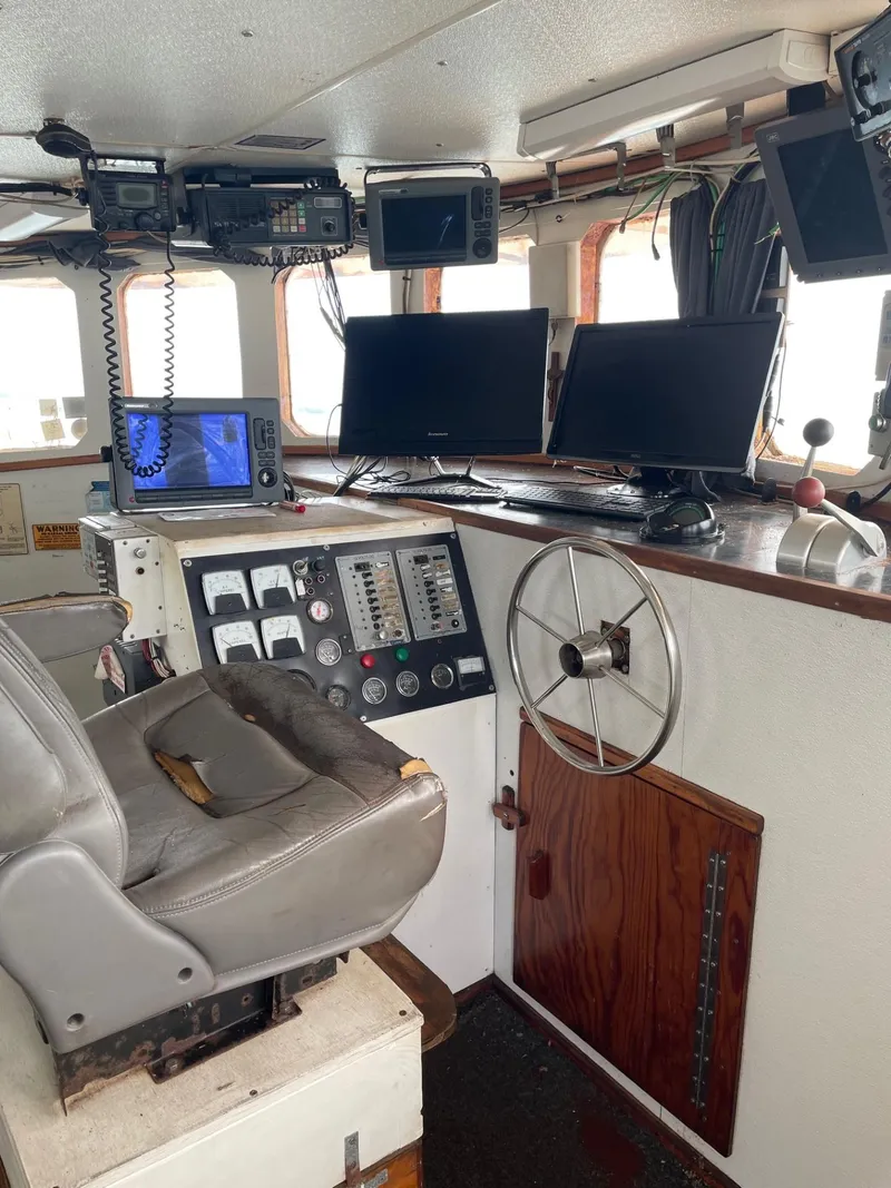 Slide: The Image of Engine room of a 1983 commercial freezer trawler with visible machinery and wiring. - 12