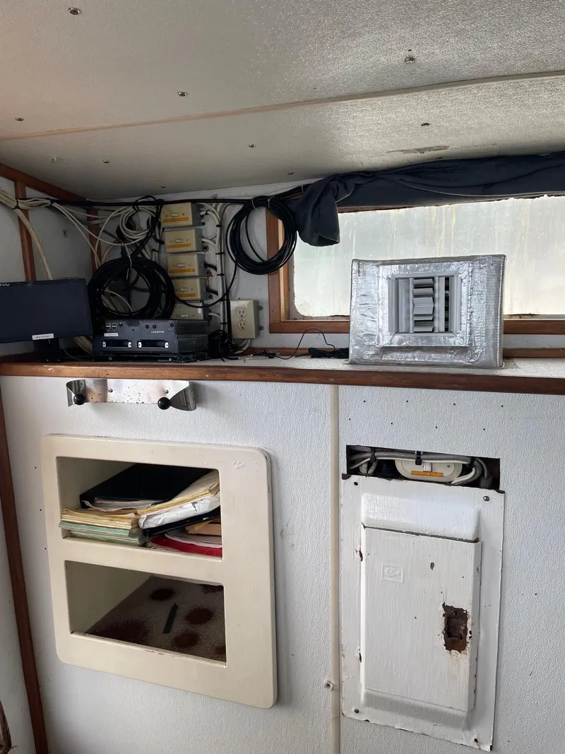 Slide: The Image of Interior of a 1983 commercial freezer trawler with control panel and seating. - 14