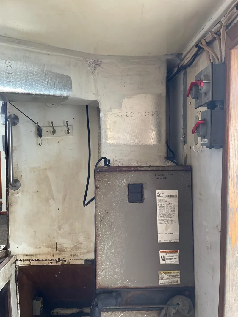 Slide: The Image of Interior of a 1983 commercial freezer trawler with electrical equipment and storage shelves. - 15