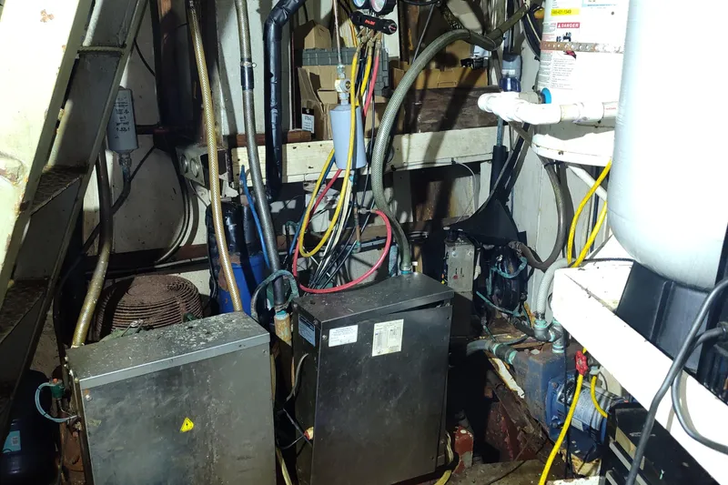 Slide: The Image of Engine room of a 1983 Commercial Freezer Trawler with various machinery and cables. - 2