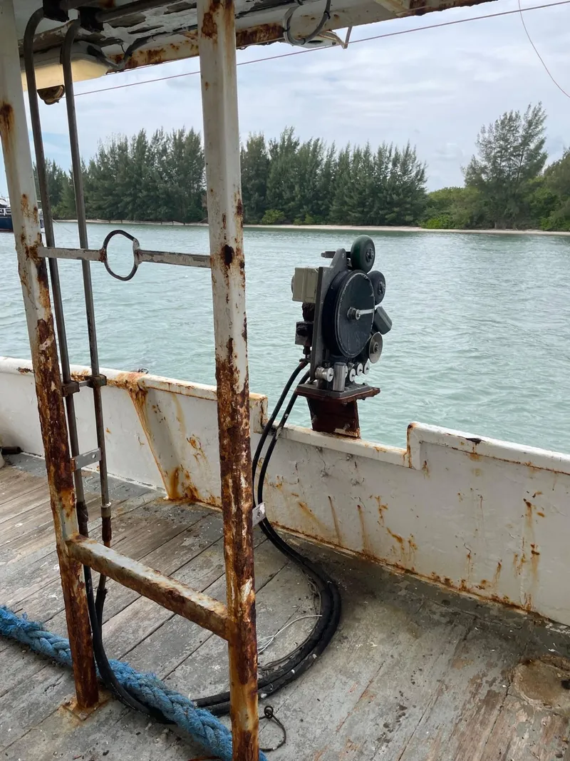 Slide: The Image of 1983 Commercial Freezer Trawler deck with visible rust and fishing equipment. - 21