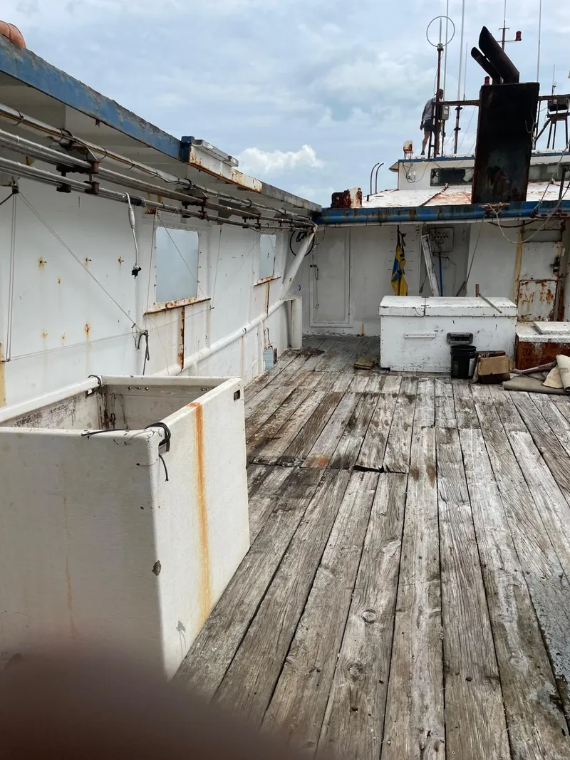 Slide: The Image of Close-up of a 1983 commercial freezer trawler's metal components and storage area. - 24