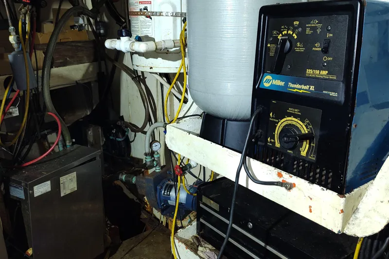 Slide: The Image of Engine room of a 1983 Commercial Freezer Trawler with various machinery and cables. - 7