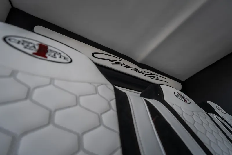 Slide: The Image of Interior of 2023 Cigarette 515 boat with branded white seats and hexagonal pattern. - 51