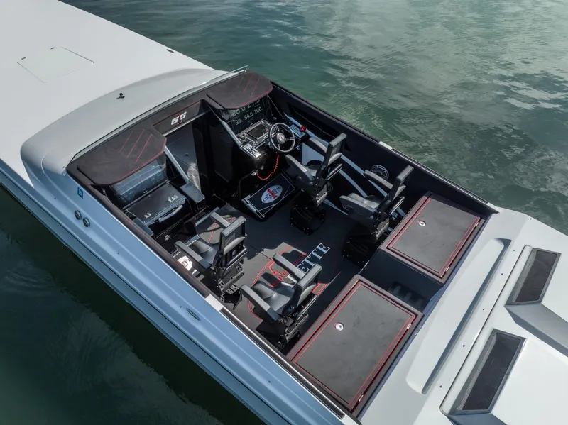 Slide: The Image of 2023 Cigarette 515 boat interior with sleek seating and modern dashboard on water. - 11