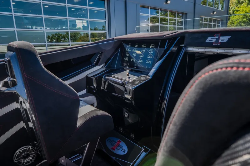 Slide: The Image of Interior of 2023 Cigarette 515 boat, featuring advanced dashboard and sleek seating design. - 49