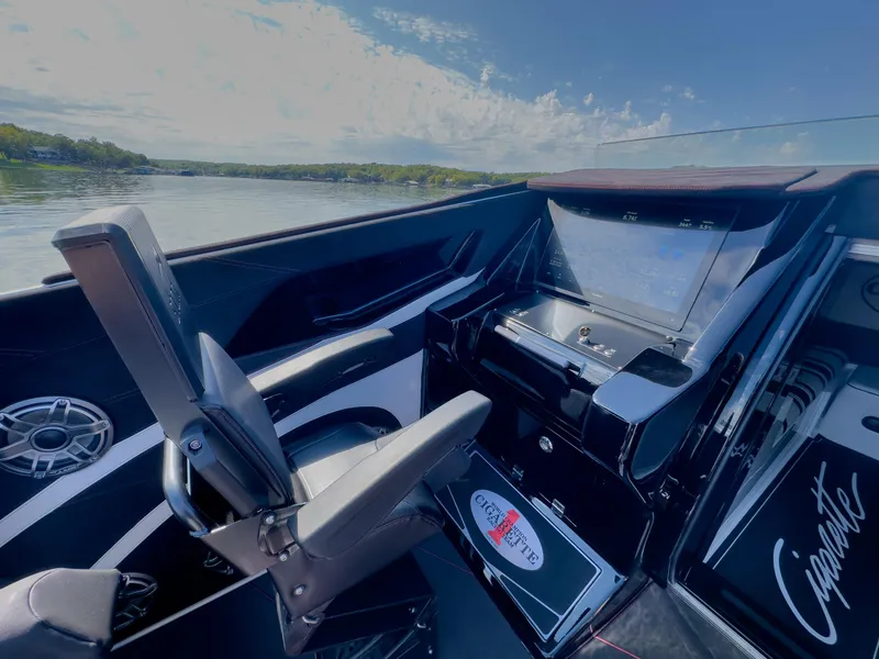 Slide: The Image of 2023 Cigarette 515 boat interior with sleek design and advanced controls on a sunny day. - 19