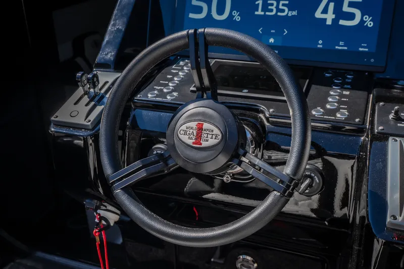 Slide: The Image of Steering wheel of 2023 Cigarette 515 boat with digital display and controls. - 64