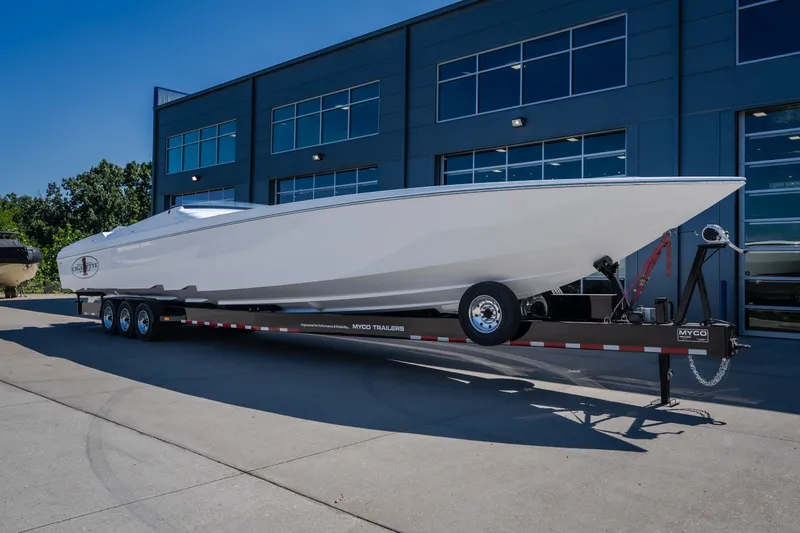 Slide: The Image of 2023 Cigarette 515 boat on trailer outside modern building. - 4