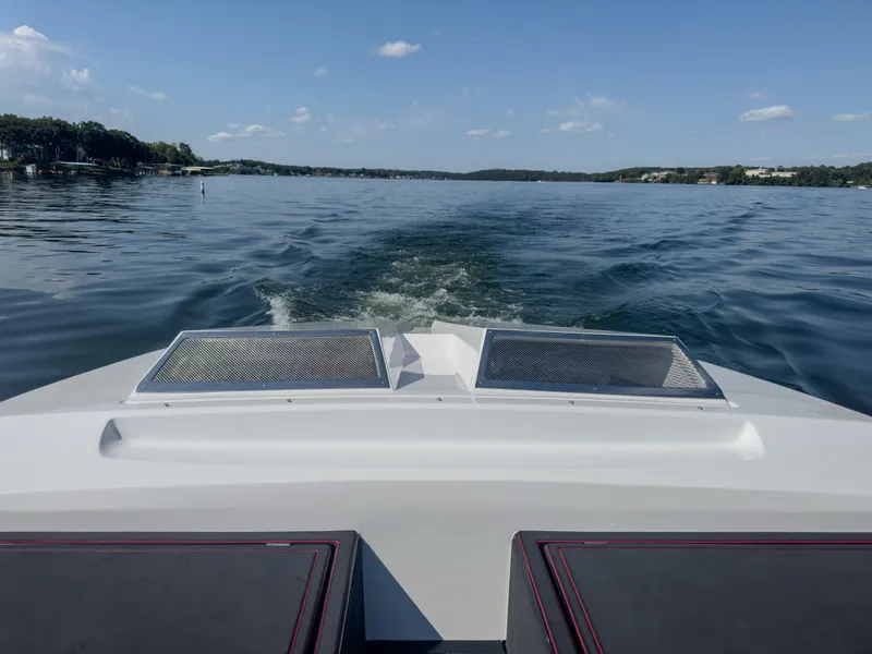 Slide: The Image of 2023 Cigarette 515 boat cruising on a calm lake under a clear blue sky. - 26