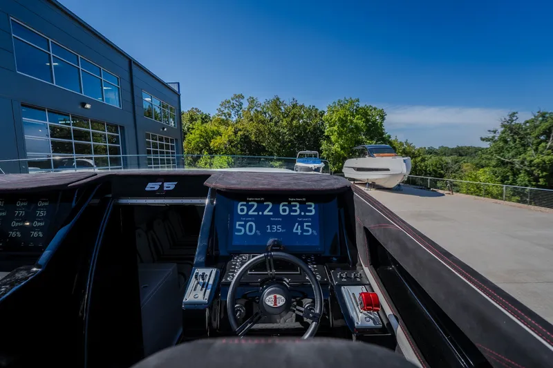 Slide: The Image of Interior view of 2023 Cigarette 515 boat dashboard with digital displays and steering wheel. - 38