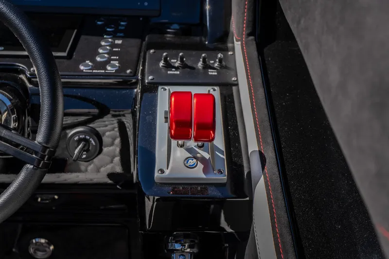 Slide: The Image of Dashboard of 2023 Cigarette 515 boat with red throttle levers and control switches. - 63