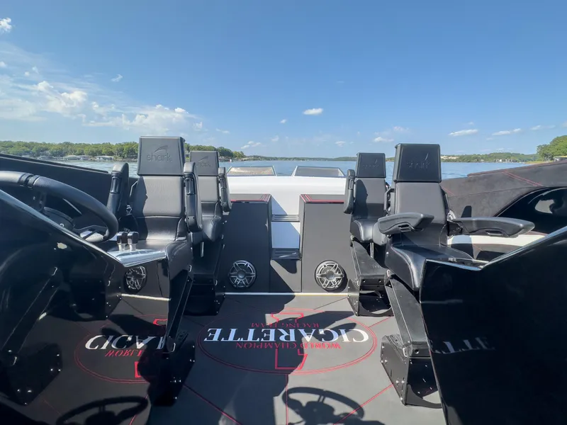 Slide: The Image of 2023 Cigarette 515 boat interior with sleek black seating and steering, on a sunny day. - 29