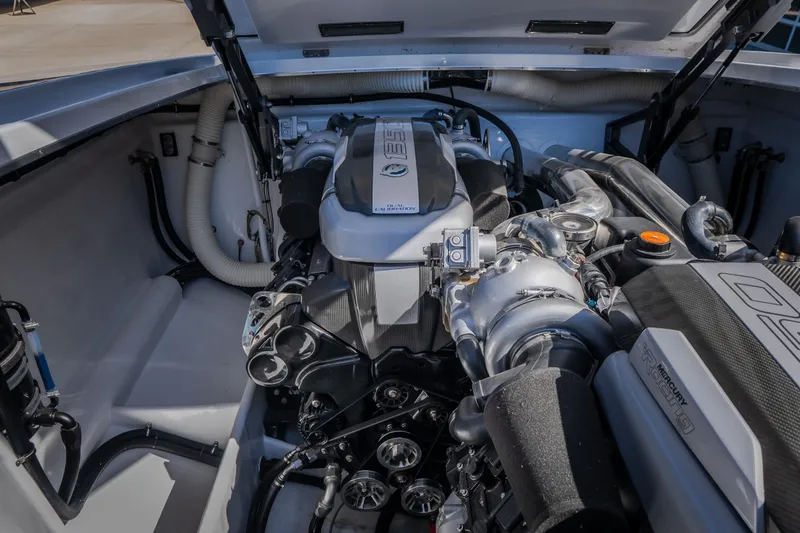 Slide: The Image of Engine compartment of 2023 Cigarette 515 boat, showcasing powerful Mercury Racing engine. - 43