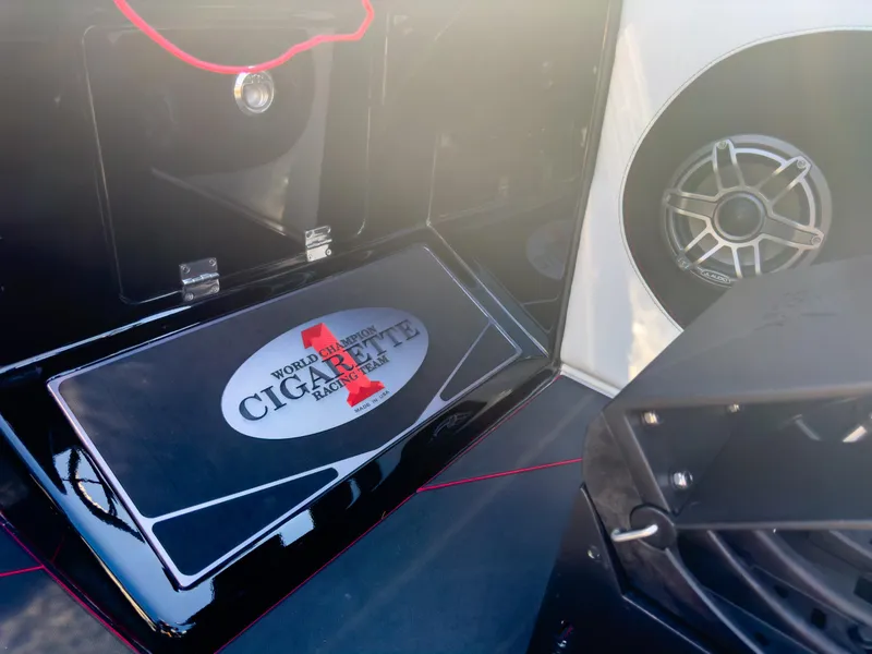Slide: The Image of 2023 Cigarette 515 boat interior with branded storage compartment and speaker. - 33