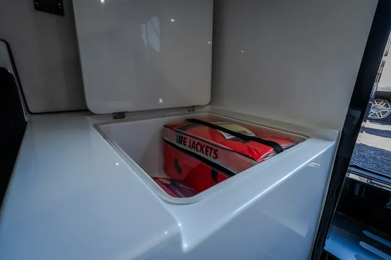 Slide: The Image of Storage compartment with life jackets in a 2023 Cigarette 515 boat. - 78