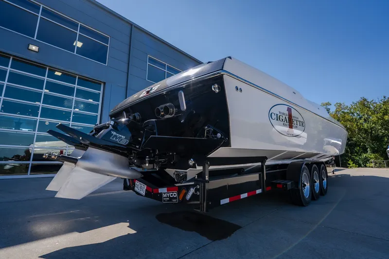 Slide: The Image of 2023 Cigarette 515 powerboat on trailer outside modern building. - 28
