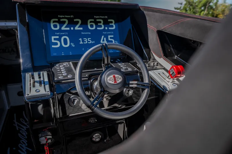 Slide: The Image of Cockpit of 2023 Cigarette 515 boat with digital display and steering wheel. - 59